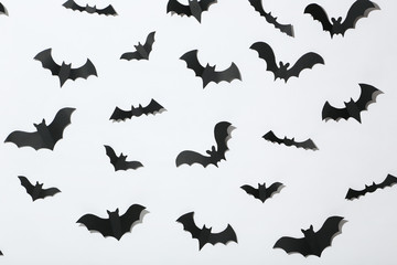 Halloween paper bats on white background