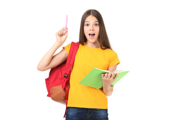 Young girl with backpack and book on white background