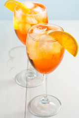 Aperol Spritz served with an orange slice in wine glasses. White background, high resolution