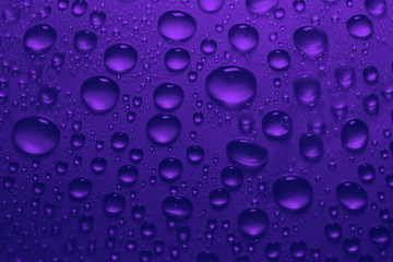 water drops on blue violet color background texture