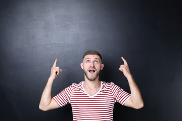 Portrait of young man on blackboard background