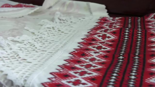 National red and white embroidery. The process of decorating decorative towels embroidered red ornament.  national red and black embroidery thread.