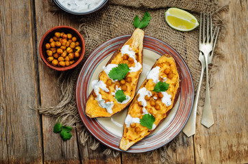 Roasted chickpeas stuffed sweet potato with Greek yogurt cilantro lime dressing