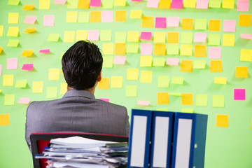 Businessman having trouble with his priorities