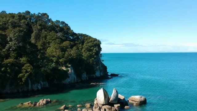 Aerial shot of the Split Apple Rock sorrounded by clear blue water in the Abel Tasman Nationalpark