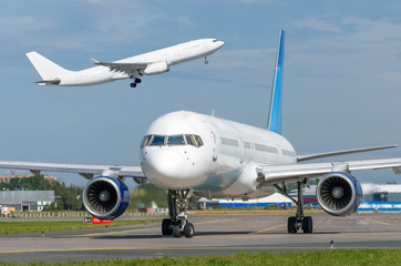 Take off aircraft and another airplane taxiing close-up cockpit cab with engine.