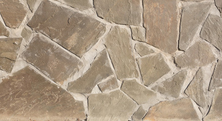 the texture of the finishing stone on the wall. Artificial stone.