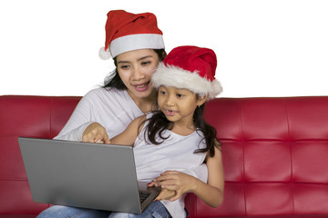 Mother and child with laptop at Christmas time