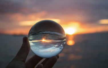 Bright Sunset Seascape with Boat on Horizon Captured in Glass Ball - 223430503