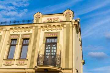 The facade of the house with a balcony and wrought-iron setting