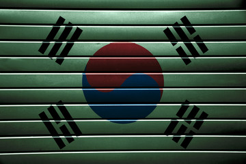 Texture of South Korea flag on green metal strips.