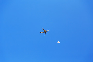 Fototapeta na wymiar plane flies high in the sky near Crescent