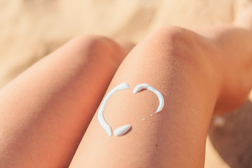 sunscreen in the form of heart on female leg