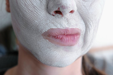 Clay mask on a woman's face. Fitness for the face.