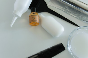 Hair dye tools on white background, space for text