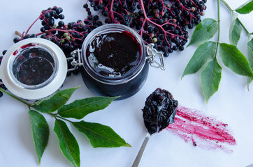 Elderberry jam on white background