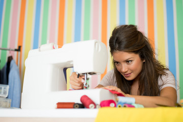 Fashion designer sewing with sewing machine