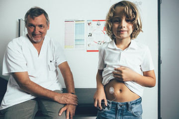 Diabetic child and the doctor in the clinic - 223434164