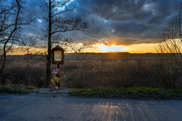 Storm clouds over an accident cross, Roadside memorial.
