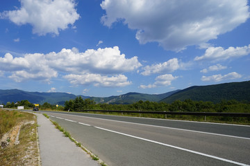 Beautiful road landscape view with clouds trees and mountains