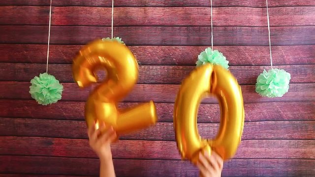 Happy twenty birthday with golden number 20 air balloons, anniversary celebration