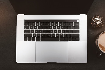 Modern computer keyboard, biscuit and coffee for break. Top view, flat lay and light effects