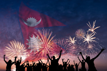 People are looking on fireworks and flag of Nepal