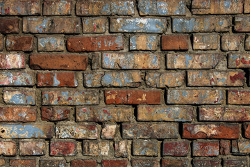 Texture of old brick wall with shabby paint