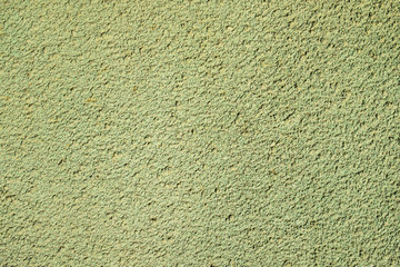 Textured surface coat plaster walls green color with yellow impregnations