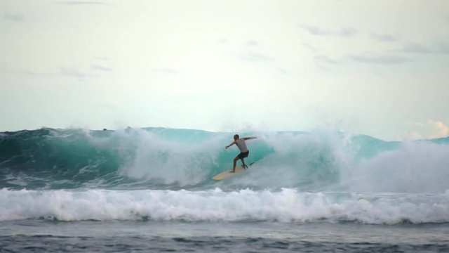 Surfer surfing on the wave and falls in the woter