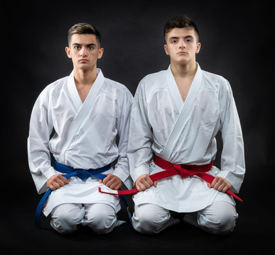 two guys karate on a dark background