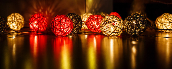 christmas lights on dark wooden background with reflections. Christmas and New Year holidays background. 