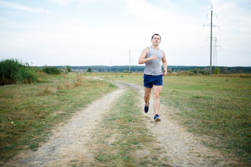 Sport and fitness runner man doing outdoors training for marathon run.