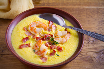 Shrimp, bacon and corn chowder. Creamy corn vegetable soup with shrimps and bacon. horizontal