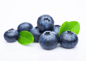 Fresh raw organic blueberries with leaf on white background. Macro close up