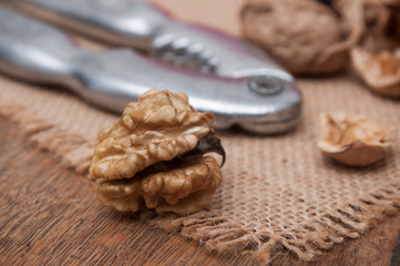 closeup of walnuts and Nutcracker on wooden background