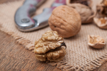 closeup of walnuts and Nutcracker on wooden background