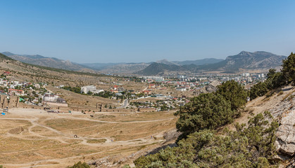 Fototapeta premium Mountain landscape with a city at the foot