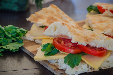 Pita bread with tomato, cheese and parsley on the grill in nature