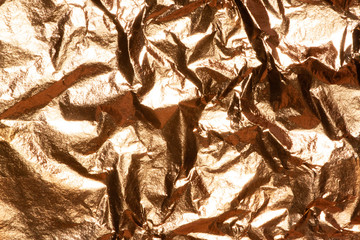 Gold bright shiny texture of a crumpled sheet.