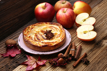 Apple tart. Gourmet traditional holiday apple pie sweet baked dessert food with cinnamon and apples on vintage background. Autumn decor. Rustic style.