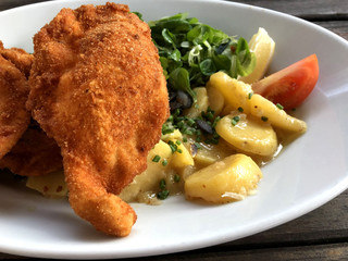 Breaded fried chicken salad with potatoes lamb's lettuce salad - Austrian Cuisine - Backhendlsalat...