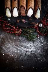 Traditional Sicilian cannoli on Christmas decoration with blank space,selective focus