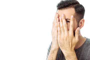 Young cheerful bearded man pointing finger at empty space on background isolated on white background