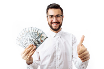 Portrait of young hipster man standing isolated on white background holding money and showing class...
