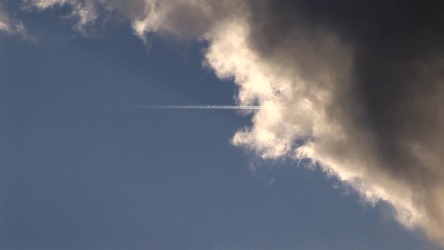 Plane Trails Disappear into Cloud