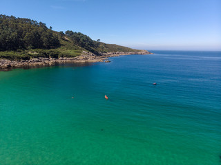  The aerial view of unrecognizable people rises paddle boarding on the surface of the water for sport, and fun. Enjoy the summer SUP activity for holidays.