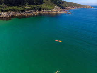  Aerial photo double canoe drone in crystal clear green sea water