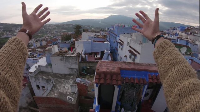 Tilt up POV, people on Morocco rooftops