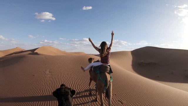 Riding camel in desert landscape, POV